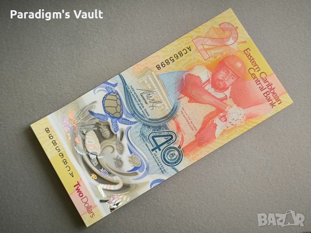 Банкнота - Източни Кариби - 2 долара (юбилейна) UNC | 2023г.