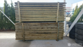 Импрегнирани дървени колове на склад, снимка 1